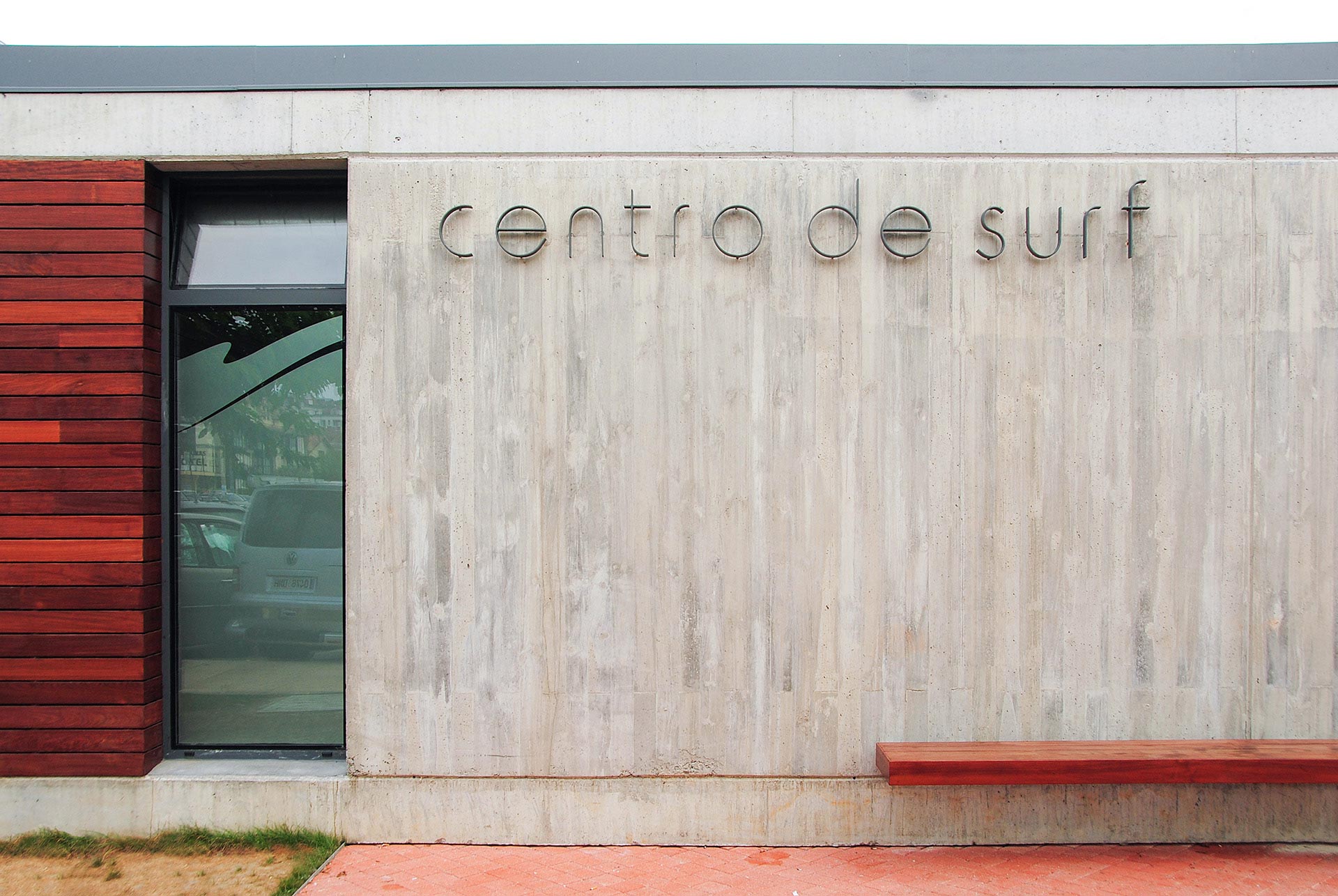 Steel sign on concrete wall of Surf Center designed by Moah Architects in Somo