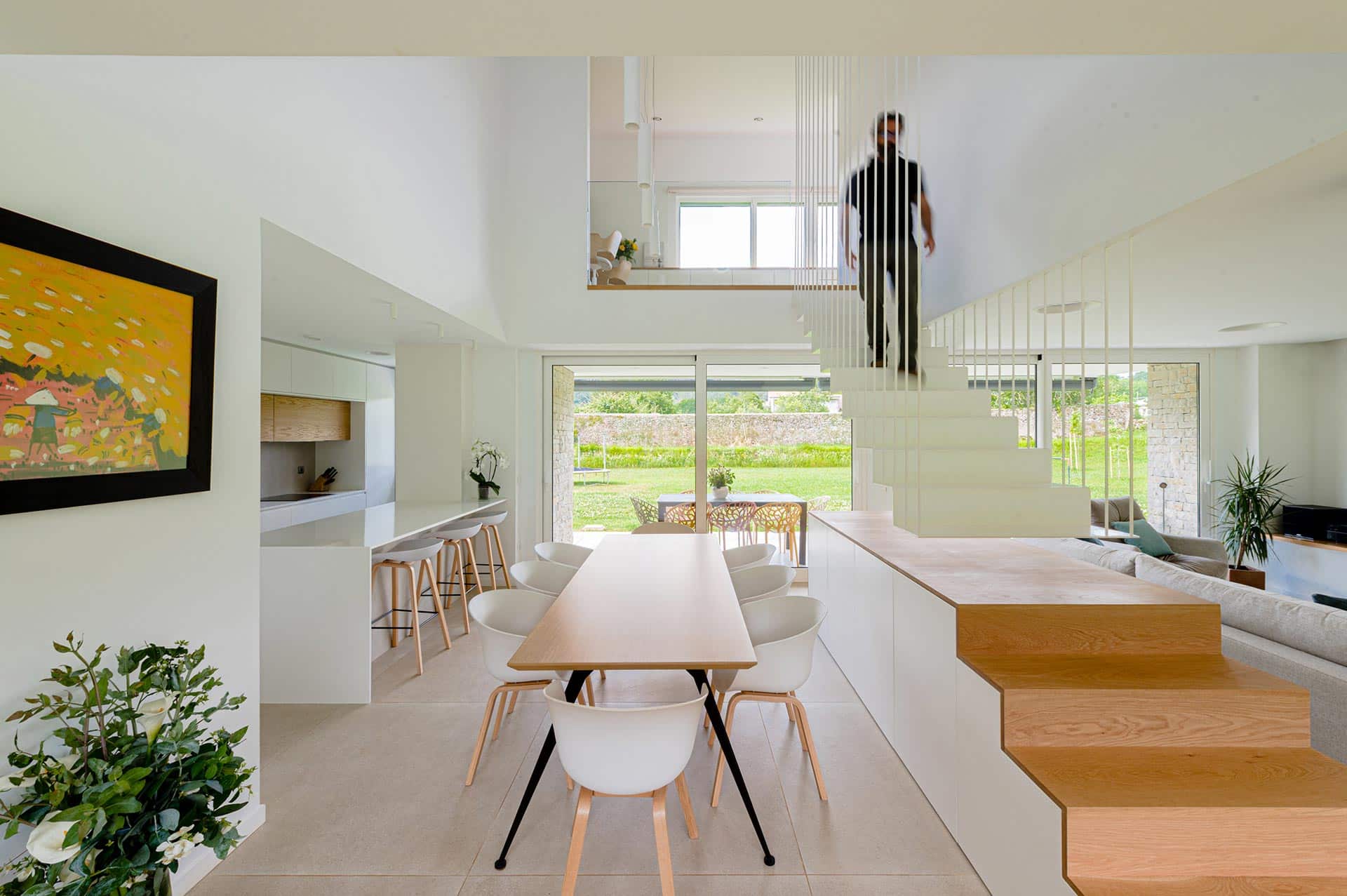 Dining room and light stairs in modern house designed by Moah Architects in Pámanes