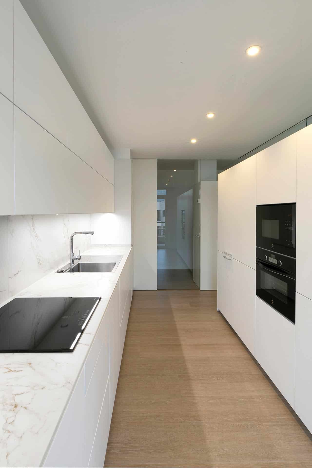 Cocina blanca minimalista diseñada por Moah Arquitectos en Cantabria