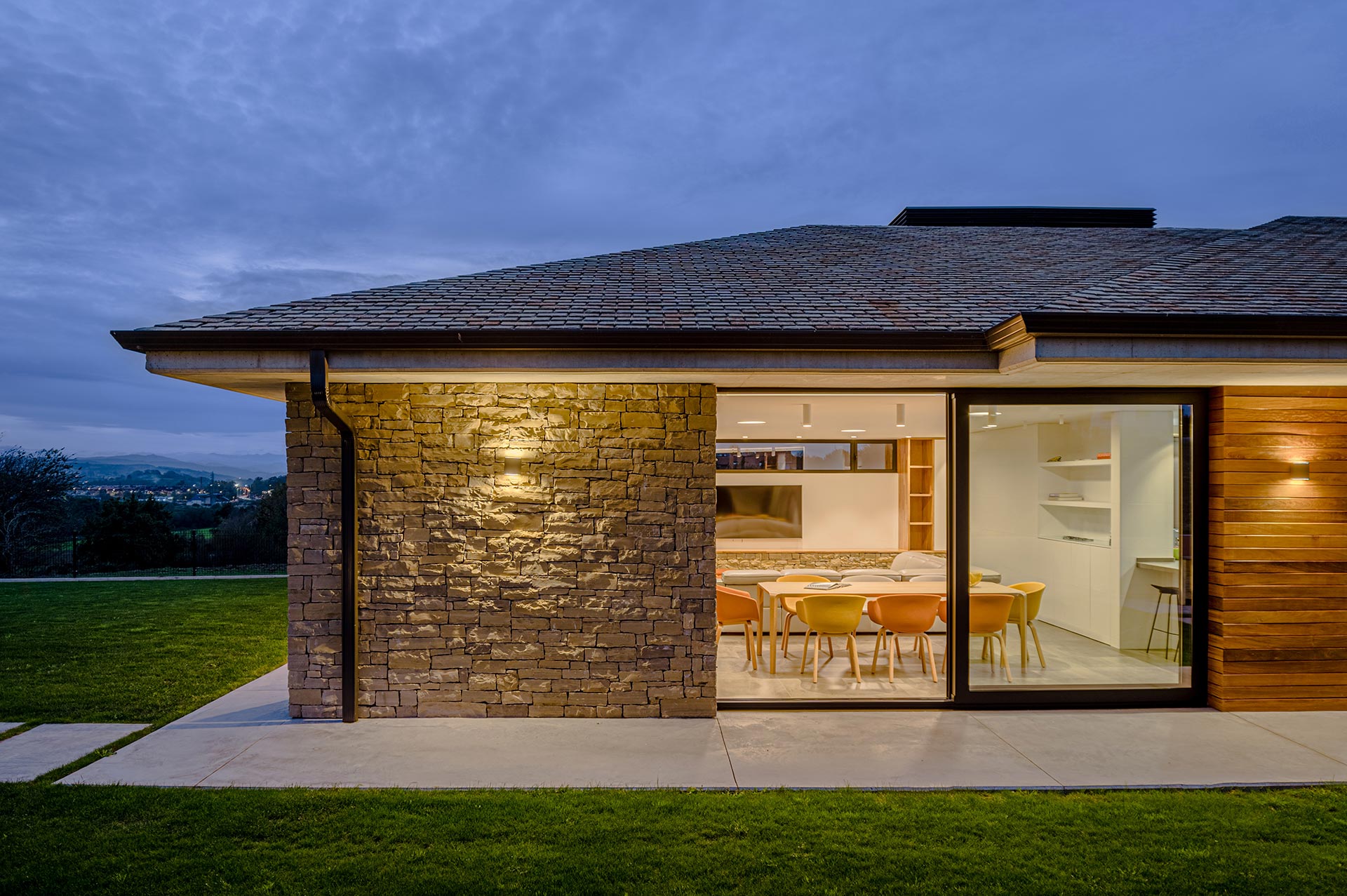 Modern house made of stone, wood, slate, and glass designed by Moah Architects in Pontejos.